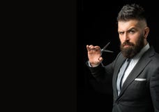 Confident barber at barbershop. Barber and hairdresser salon. Beard care, perfect beard. Bearded man in formal business
