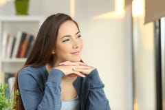 Confident pensive woman looking at side at home stock photo Confident pensive woman looking at side at home stock photo