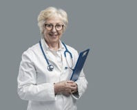 Confident senior female doctor posing and smiling stock photography Confident senior female doctor posing and smiling stock photography