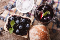 Confiture de myrtille et plan rapproché doux de petit pain sur la table Horizontal à Photographie stock Confiture de myrtille et plan rapproché doux de petit pain sur la table Horizontal à Photographie stock