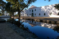 Cape Dutch style farm building at Groot Constantia, Cape Town, South Africa, reflected in a still pond in the early morning. royalty free stock images Cape Dutch style farm building at Groot Constantia, Cape Town, South Africa, reflected in a still pond in the early morning. royalty free stock images
