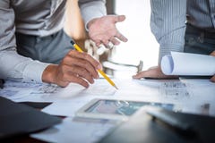 Construction engineering or architect discuss a blueprint while checking information on drawing and sketching, meeting for stock photo Construction engineering or architect discuss a blueprint while checking information on drawing and sketching, meeting for stock photo