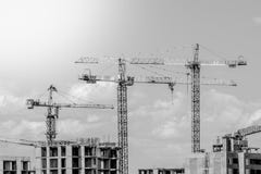 Construction in the rays of sunset. tower cranes silhouettes over amazing sunset sky stock photo Construction in the rays of sunset. tower cranes silhouettes over amazing sunset sky stock photo