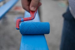Painting wooden board with paint roller royalty free stock image Painting wooden board with paint roller royalty free stock image