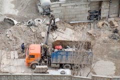 Construction site debris removal. Truck with crane loading for Scrap metal stock photo Construction site debris removal. Truck with crane loading for Scrap metal stock photo