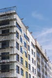 Construction site of modern building with scaffolding on its facade stock photos Construction site of modern building with scaffolding on its facade stock photos