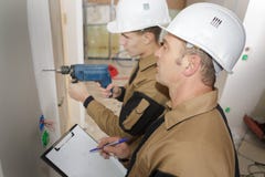 Construction site workers drilling with machine stock photo Construction site workers drilling with machine stock photo