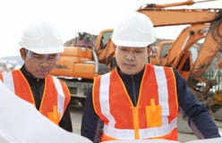 Construction worker with heavy equipment on the background stock photography Construction worker with heavy equipment on the background stock photography
