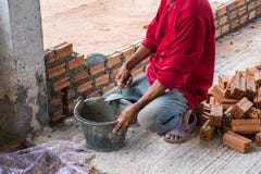 Construction worker placing bricks on cement for building exteri stock photo Construction worker placing bricks on cement for building exteri stock photo
