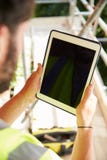 Construction Worker Using Digital Tablet On Building Site stock images Construction Worker Using Digital Tablet On Building Site stock images