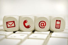 Contact us cubes. Website and Internet contact us page concept with icons on cubes on a keyboard Contact us cubes. Website and Internet contact us page concept with icons on cubes on a keyboard