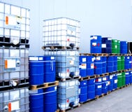 Container and oil drums. White container and blue drums on an industrial storage site Container and oil drums. White container and blue drums on an industrial storage site
