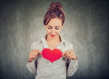 Content woman holding red heart on chest stock images Content woman holding red heart on chest stock images