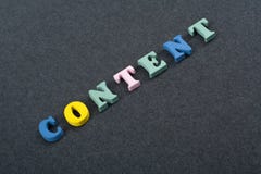 CONTENT word on black board background composed from colorful abc alphabet block wooden letters, copy space for ad text royalty free stock photography CONTENT word on black board background composed from colorful abc alphabet block wooden letters, copy space for ad text royalty free stock photography