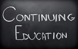 Continuing education. Written on classroom blackboard Continuing education. Written on classroom blackboard