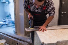 Man Worker Contractor Cutting Laminate Flooring Lengthwise