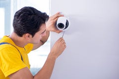 The contractor installing surveillance cctv cameras in office royalty free stock photo The contractor installing surveillance cctv cameras in office royalty free stock photo