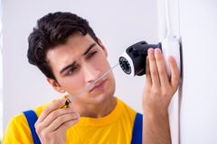 The contractor installing surveillance cctv cameras in office Stock Photos The contractor installing surveillance cctv cameras in office Stock Photos