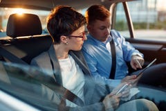 Conversation of business colleagues in driving car Royalty Free Stock Image Conversation of business colleagues in driving car Royalty Free Stock Image
