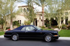 Convertible car standing outside of a luxury house Stock Photos Convertible car standing outside of a luxury house Stock Photos