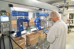Conveyor belt worker operates a robot that transports insulin ba royalty free stock photo Conveyor belt worker operates a robot that transports insulin ba royalty free stock photo