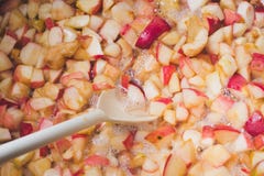 Cook apple jam and stir with a white plastic spoon. process of m royalty free stock image Cook apple jam and stir with a white plastic spoon. process of m royalty free stock image