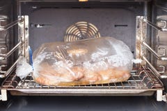 Cooking chicken in the oven on the oven bag Royalty Free Stock Photos Cooking chicken in the oven on the oven bag Royalty Free Stock Photos