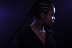 Cool and Beautiful Black Female Model Looking Away In Purple Light stock photography Cool and Beautiful Black Female Model Looking Away In Purple Light stock photography