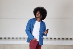 Cool black guy listening to music on mobile phone Stock Photo Cool black guy listening to music on mobile phone Stock Photo