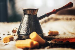 Coffee background. Vintage copper turkish coffee pot, cezve or ibrik, roasted coffee beans on blue wooden background. near round w royalty free stock photography Coffee background. Vintage copper turkish coffee pot, cezve or ibrik, roasted coffee beans on blue wooden background. near round w royalty free stock photography