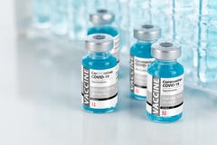 Coronavirus COVID-19 Vaccine Vials Near Test Tubes On Reflective Surface Stock Photos