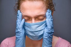 Coronavirus COVID-19. Pandemic background. Face of tired woman in medical mask and gloves. Despaired female and new
