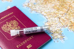 Coronavirus, travel and test concept, tube for COVID-19 PCR testing and passport on tourist map