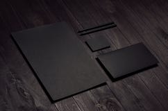 Corporate identity set of blank black letterhead, envelope, business card on dark wood board, inclined. stock images Corporate identity set of blank black letterhead, envelope, business card on dark wood board, inclined. stock images