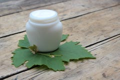 Cosmetic cream with grape leaf stock photos Cosmetic cream with grape leaf stock photos