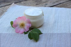 Cosmetic cream with rose hip flower stock photos Cosmetic cream with rose hip flower stock photos