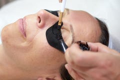 Cosmetician coloring eyelashes stock images Cosmetician coloring eyelashes stock images