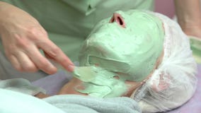 Cosmetician που εφαρμόζει την του προσώπου μάσκα άλατος αλγινικού οξέος φιλμ μικρού μήκους Cosmetician που εφαρμόζει την του προσώπου μάσκα άλατος αλγινικού οξέος φιλμ μικρού μήκους