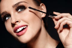 Cosmetics. Beautiful Woman With Perfect Makeup Applying Mascara stock photo Cosmetics. Beautiful Woman With Perfect Makeup Applying Mascara stock photo