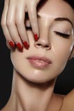 Cosmetics, manicure on nails with bright red polish. Dark red lips make-up and nail color royalty free stock photos Cosmetics, manicure on nails with bright red polish. Dark red lips make-up and nail color royalty free stock photos