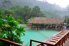 Costa Rica Tourists enjoying hot springs in rain