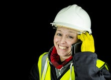 Costruttore femminile felice sul telefono immagini stock libere da diritti Costruttore femminile felice sul telefono immagini stock libere da diritti