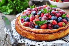 Cottage cheese casserole with fresh strawberries, blueberries, raspberries and mint and powdered sugar. Dinner Royalty Free Stock Photos Cottage cheese casserole with fresh strawberries, blueberries, raspberries and mint and powdered sugar. Dinner Royalty Free Stock Photos