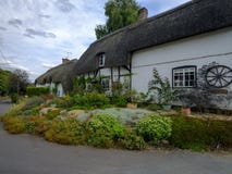 Cottage tipico del paese del Hampshire - met? armata in legno e ricoperta di paglia - con il giardino abbastanza anteriore nel vi immagini stock libere da diritti Cottage tipico del paese del Hampshire - met? armata in legno e ricoperta di paglia - con il giardino abbastanza anteriore nel vi immagini stock libere da diritti