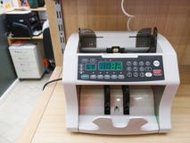 The counting machine counts many bills for one hundred American dollars of a new sample. The counting of the money. The concept of royalty free stock photo The counting machine counts many bills for one hundred American dollars of a new sample. The counting of the money. The concept of royalty free stock photo