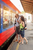A couple of backpacker tourists waiting to board a train Royalty Free Stock Images A couple of backpacker tourists waiting to board a train Royalty Free Stock Images