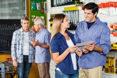 Couple Buying Tool Set In Hardware Store stock photo Couple Buying Tool Set In Hardware Store stock photo