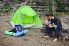 Couple camping in the mountains, the tent, two backpacks near a tourist track in mountains royalty free stock image Couple camping in the mountains, the tent, two backpacks near a tourist track in mountains royalty free stock image
