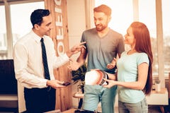 Couple Choosing Upholstery With Furniture Seller. royalty free stock image Couple Choosing Upholstery With Furniture Seller. royalty free stock image