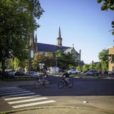 A couple cycling in Charlottetown in the morning with St.Dunstan`s Basilica Cathedra in the background royalty free stock photos A couple cycling in Charlottetown in the morning with St.Dunstan`s Basilica Cathedra in the background royalty free stock photos
